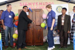 Another photo from first inauguration, with donor presnting gift of a storage cabinet for textbooks.