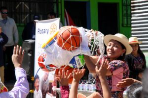 Students celebrating the gift of sports equipment to their school at an inauguration ceremony in Guatemala